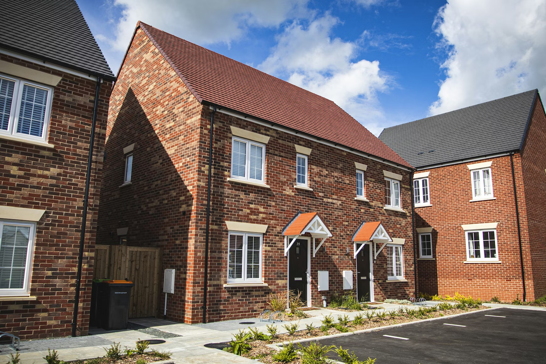Newly built UK red-brick semi-detached homes on a residential street